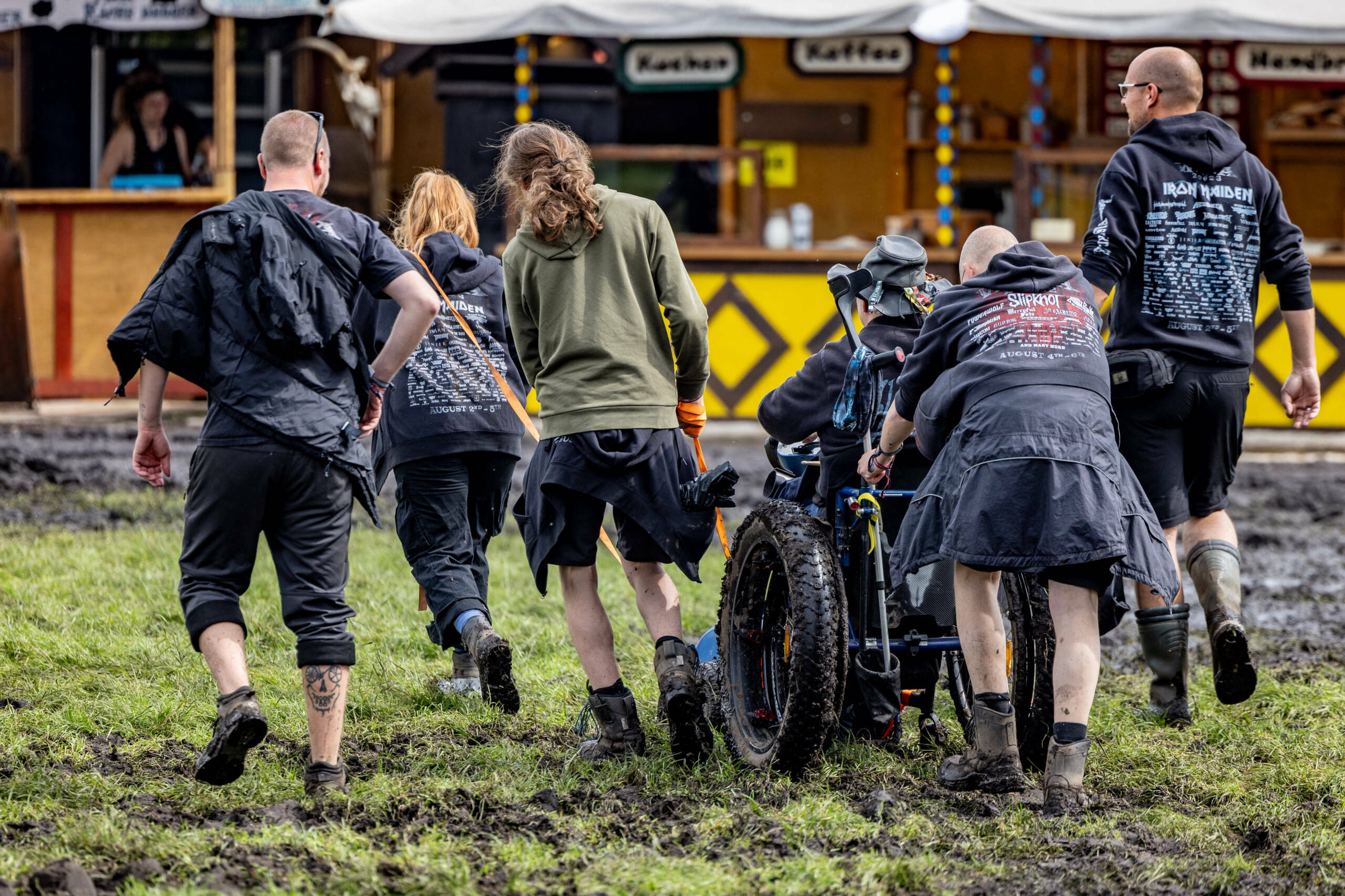 Festival-goers walk through the mud as they attend the Wacken Open Air music festival on August 2, 2023. The heavy metal m...