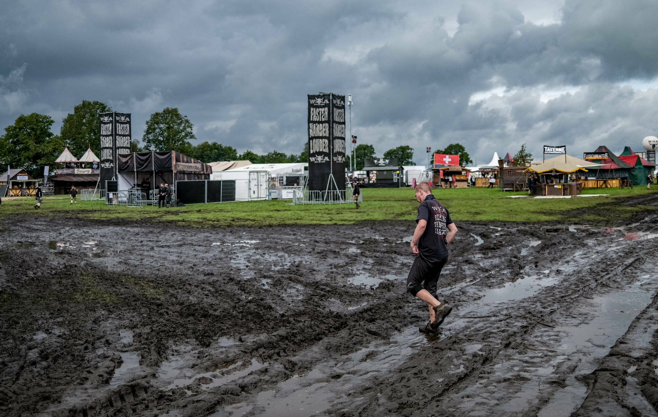 A festival-goer walks through the mud as he attends the Wacken Open Air music festival on August 2, 2023. The heavy metal ...