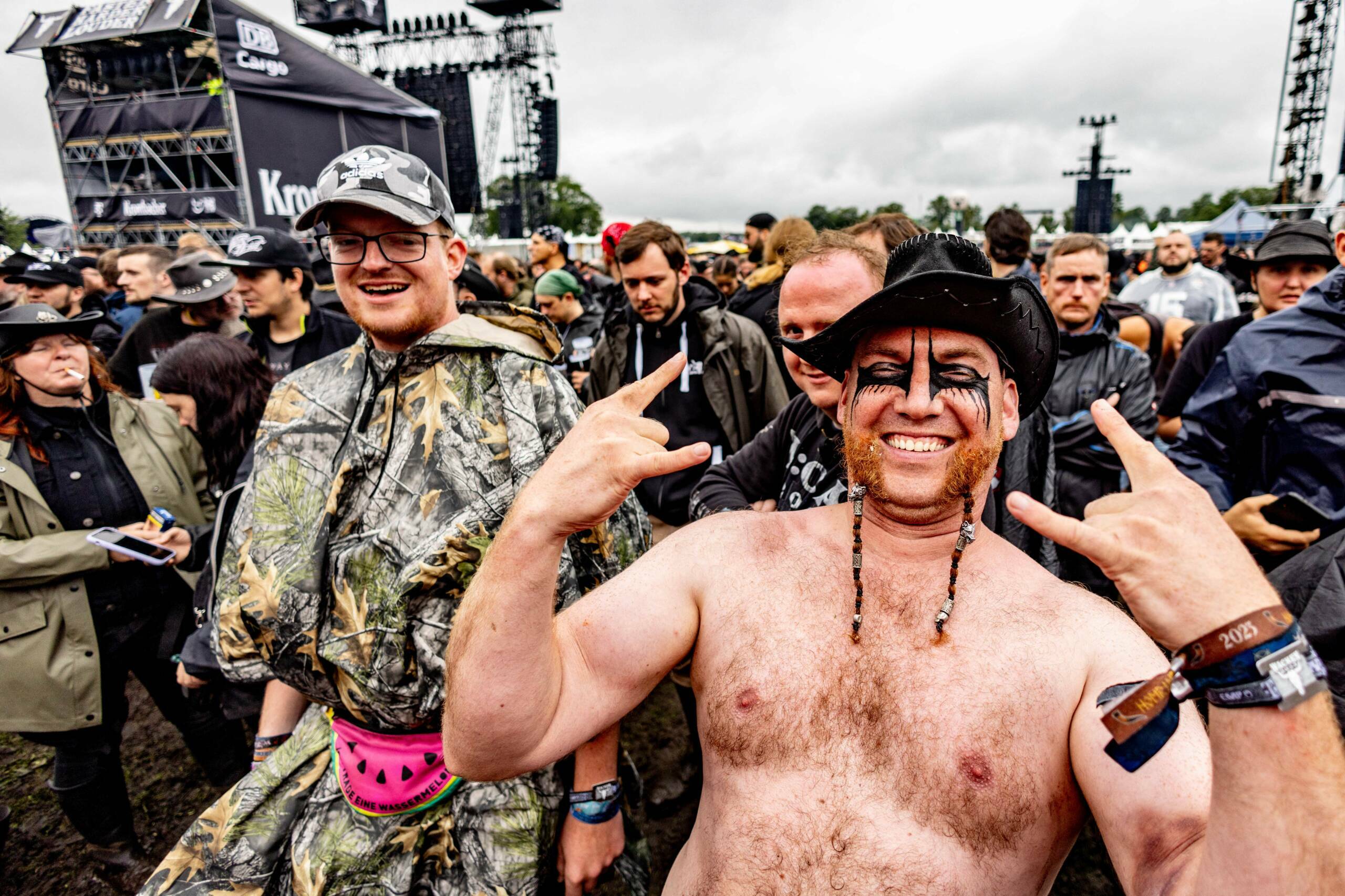 Festival-goers cheer after the opening of the "infield" in front of the main stages at the Wacken Open Air music festival ...