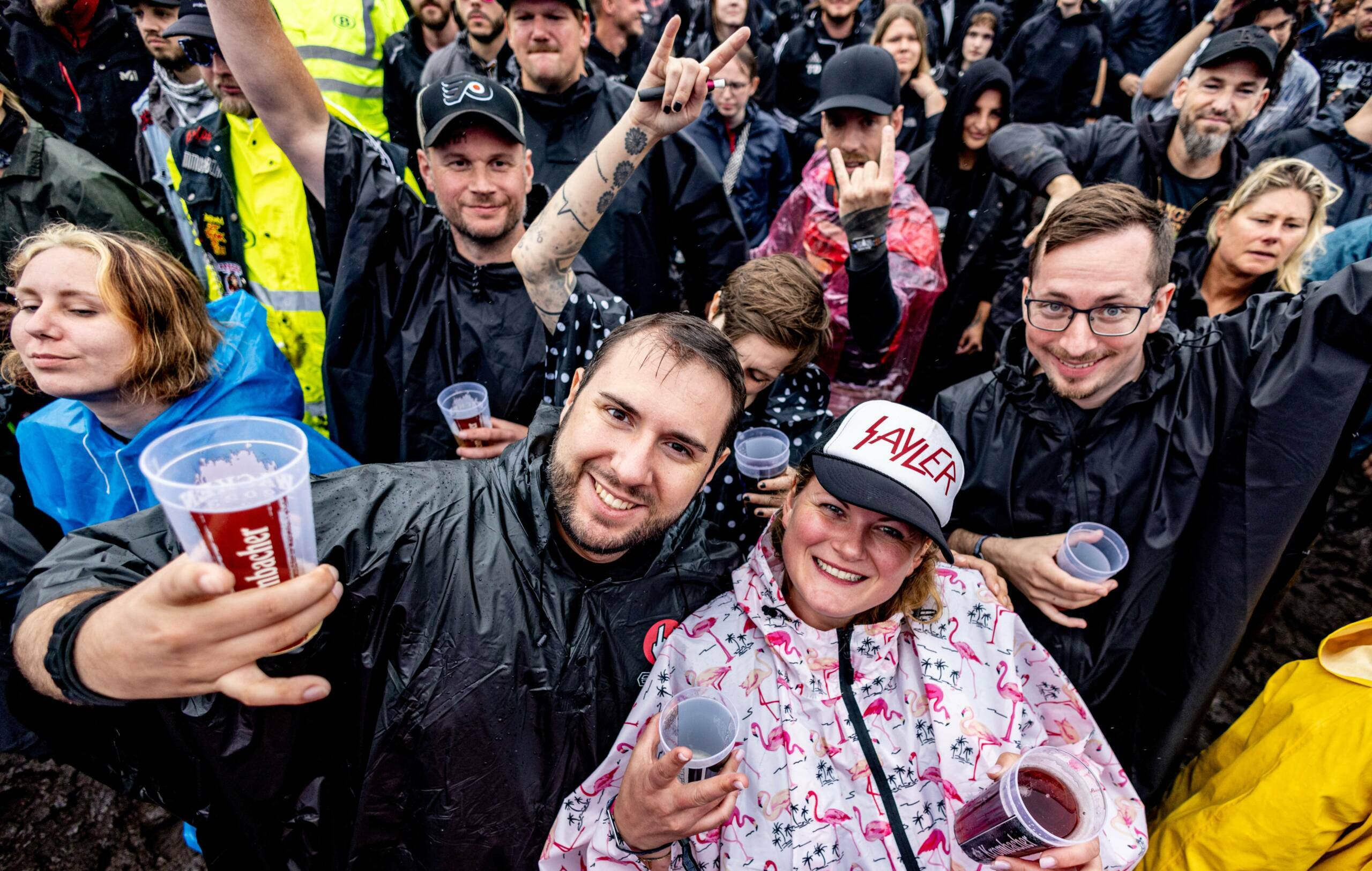 Festival-goers cheer after the opening of the "infield" in front of the main stages at the Wacken Open Air music festival ...