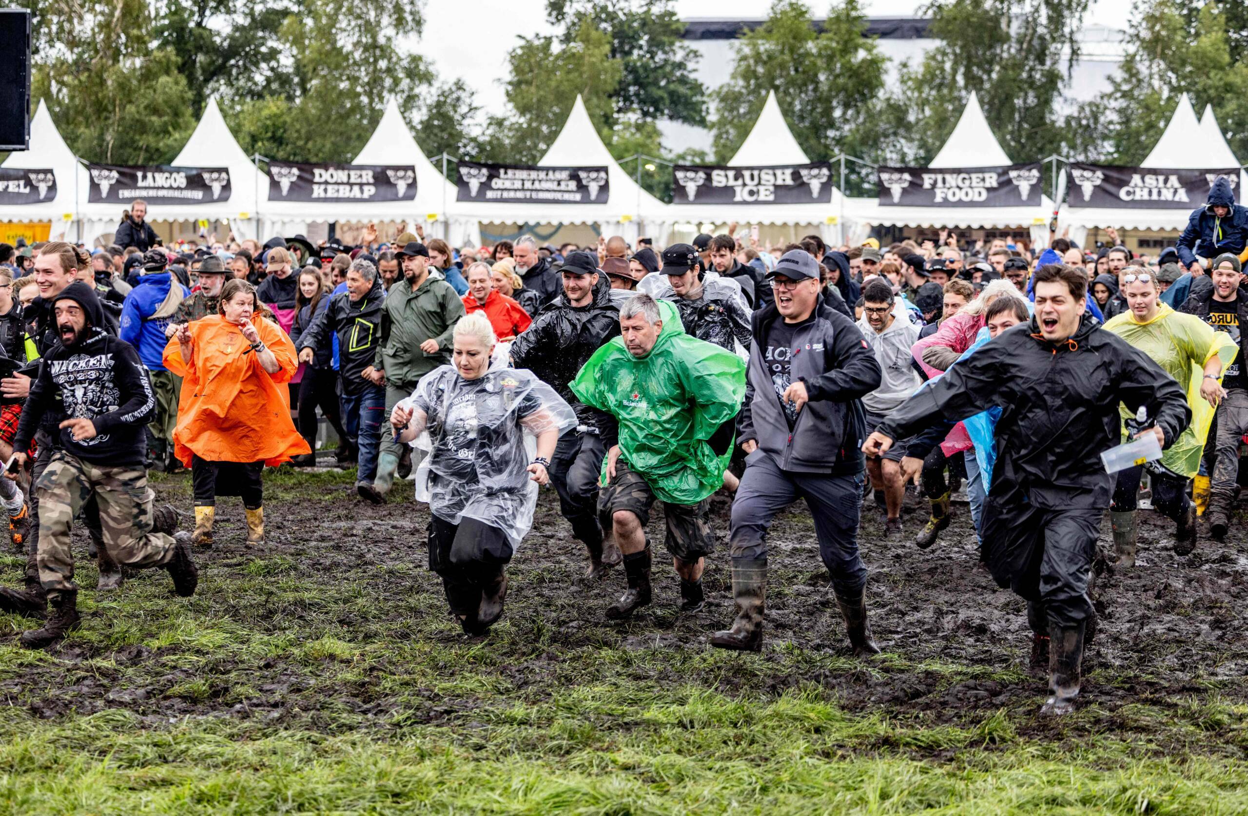 Festival-goers run to get the best spots after the opening of the "infield" in front of the main stages at the Wacken Open...