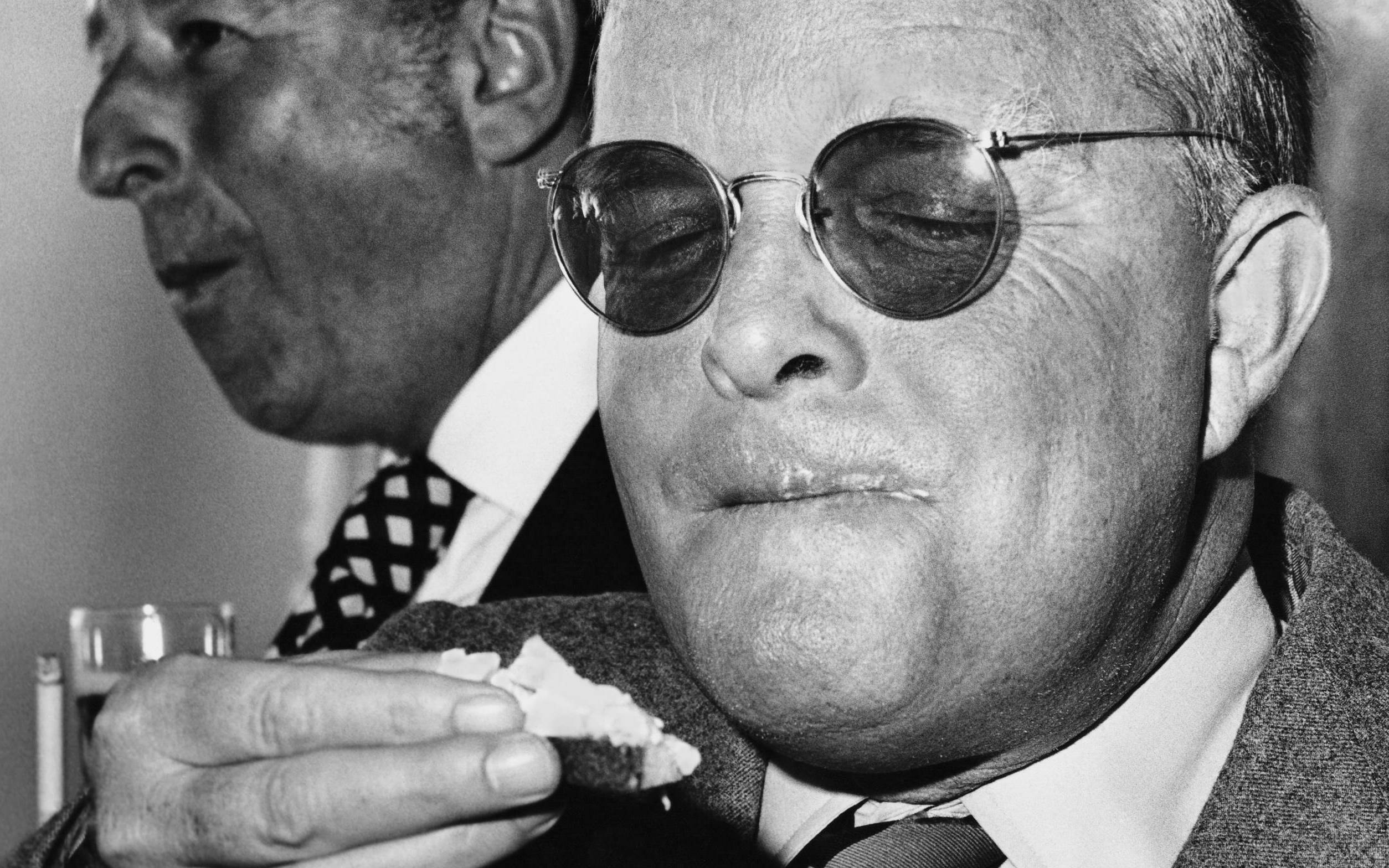 View of American author Truman Capote (born Truman Persons, 1924 - 1984) as he eats an hors d'oeuvre, San Francisco, Calif...