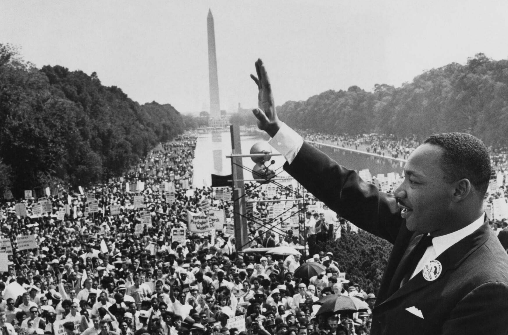 American minister and civil rights leader Dr Martin Luther King Jr (1929 - 1968) waves to the crowd of more than 200,000 p...