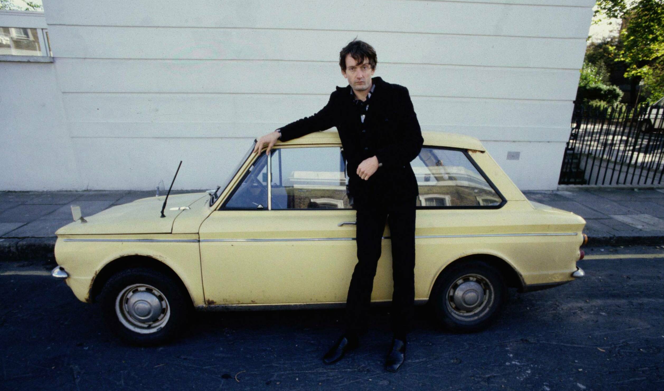 Pulp singer Jarvis Cocker, portrait, standing by a Hillman Imp car, London , United Kingdom, 1991. (Photo by Martyn Goodac...