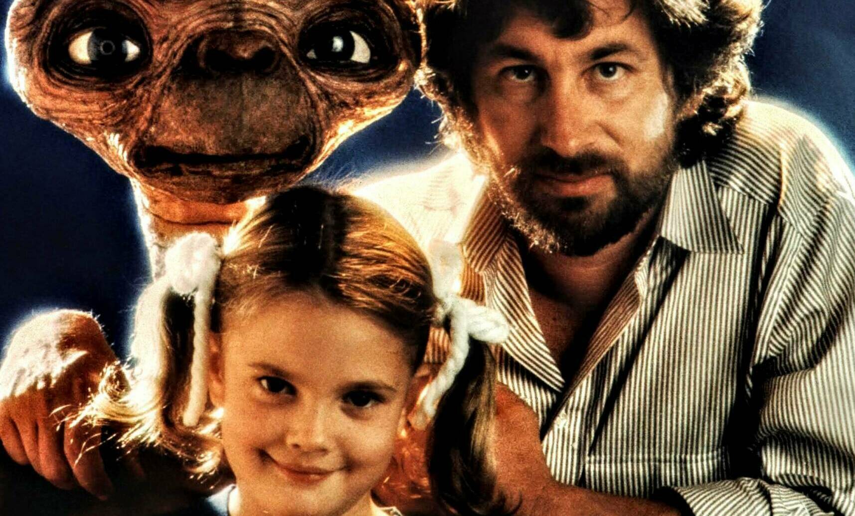 Director Steven Spielberg and actress Drew Barrymore pose with E.T. at Carlo Rimbaldi studio in April, 1982 in Los Angeles...