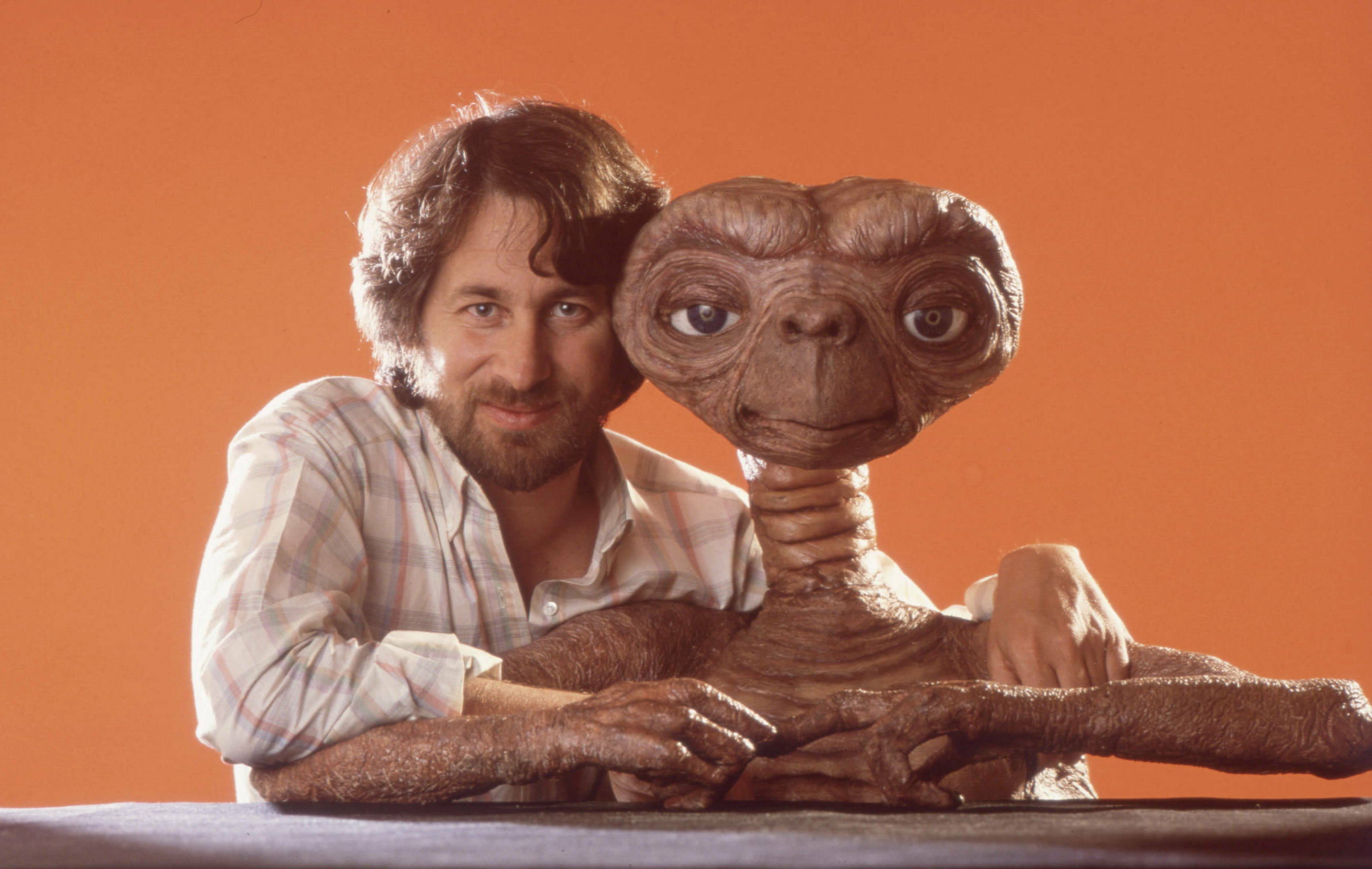 Director Steven Spielberg poses with E.T. at Carlo Rimbaldi studio in April, 1982 in Los Angeles, California.  (Photo by M...