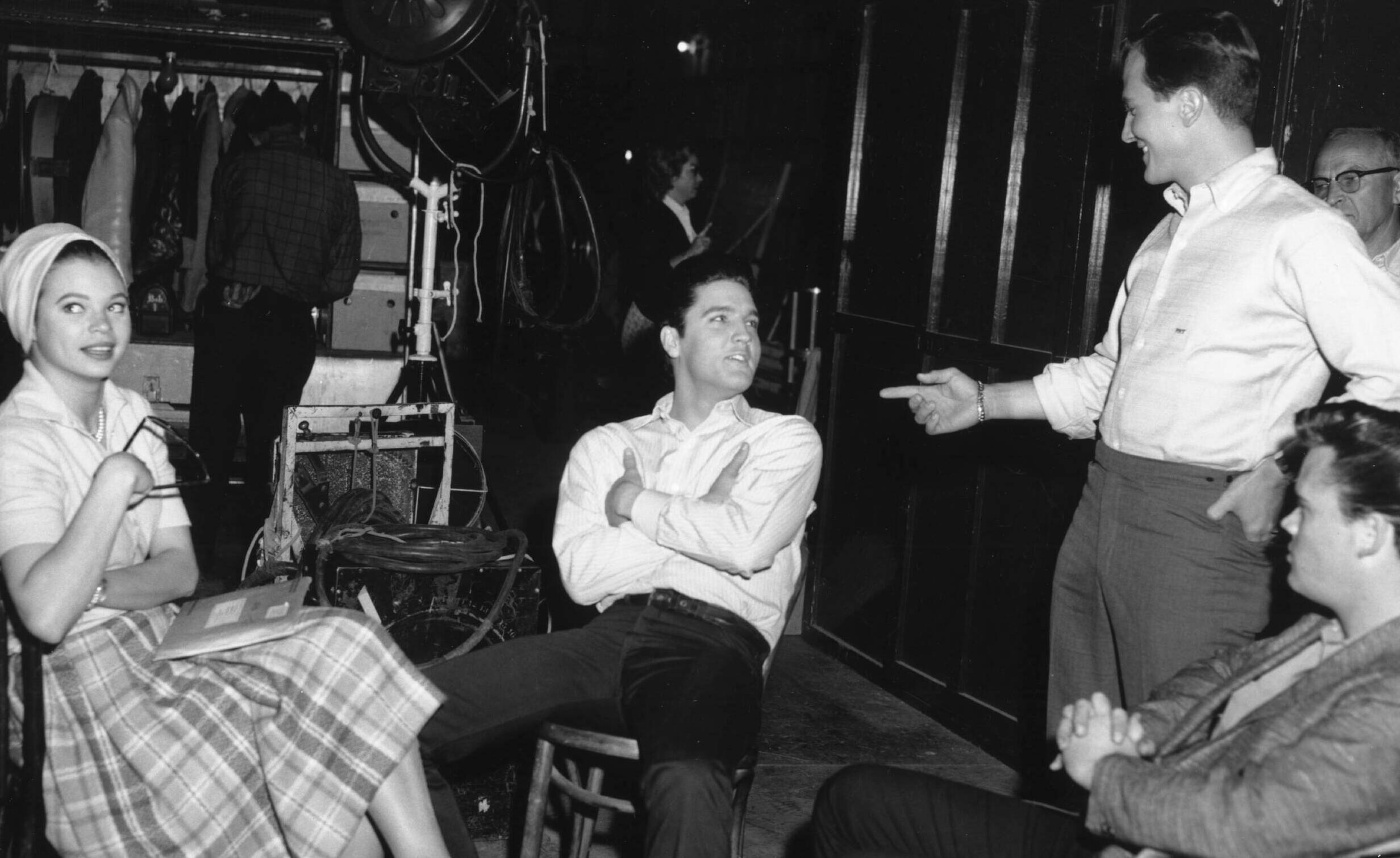 HOLLYWOOD - 1960: Rock and roll singer Elvis Presley behind the scenes at a movie set talking to fans in 1960. (Photo by M...
