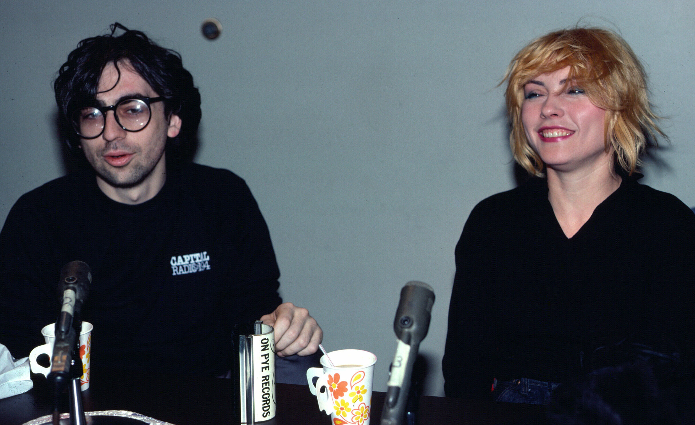 View of American New Wave musicians Chris Stein and Debbie Harry, both of the group Blondie, during an interview at WNEW-F...