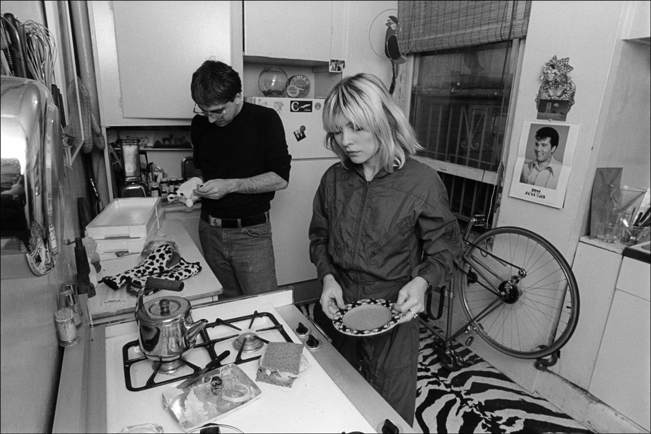 American musicians Chris Stein and Debbie Harry, both of the group Blondie, cook in their kitchen, New York, New York, Nov...