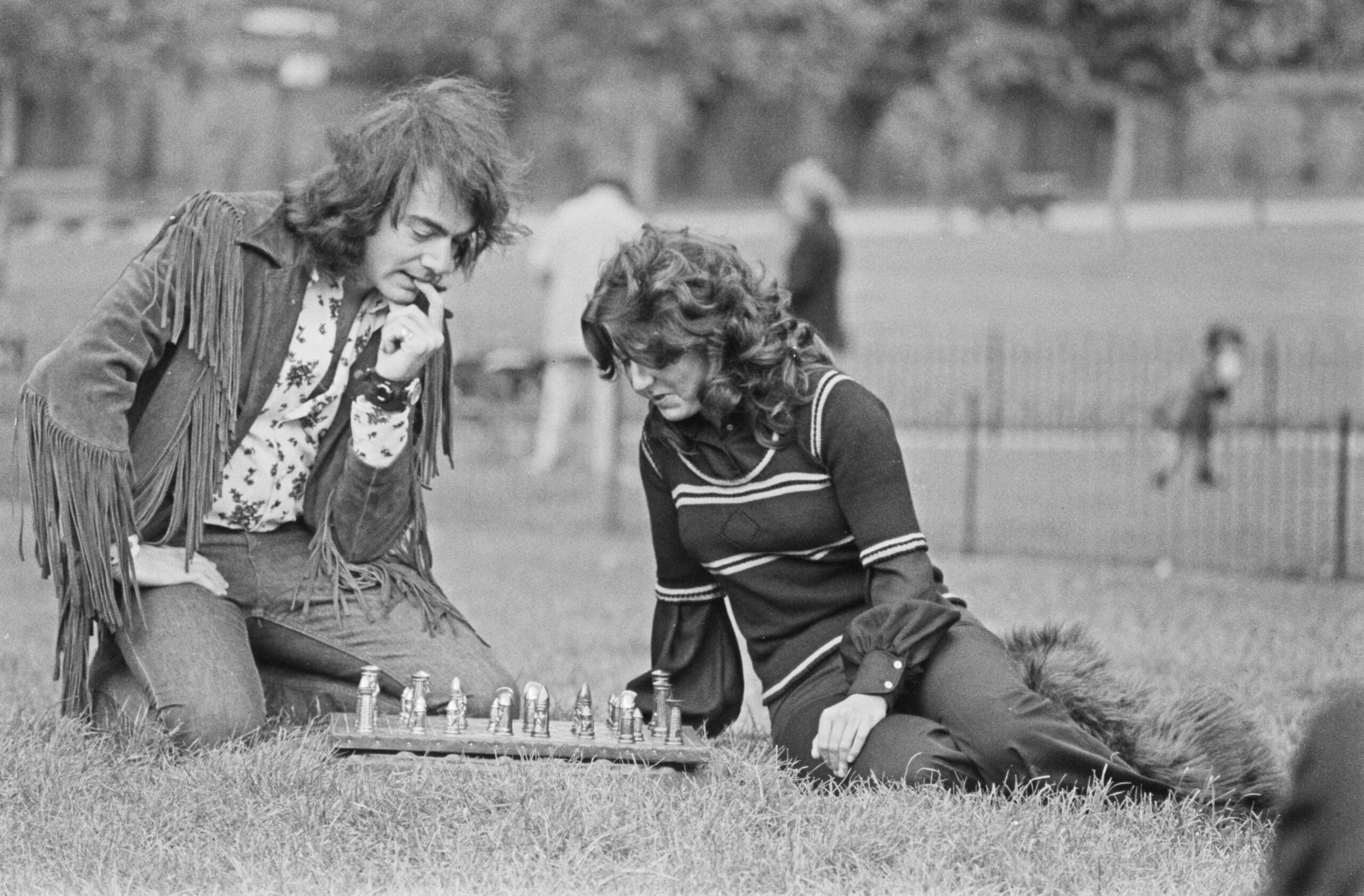 American singer-songwriter Neil Diamond plays chess in Kensington Gardens, London, with fan Joy Anderson (right), who pres...