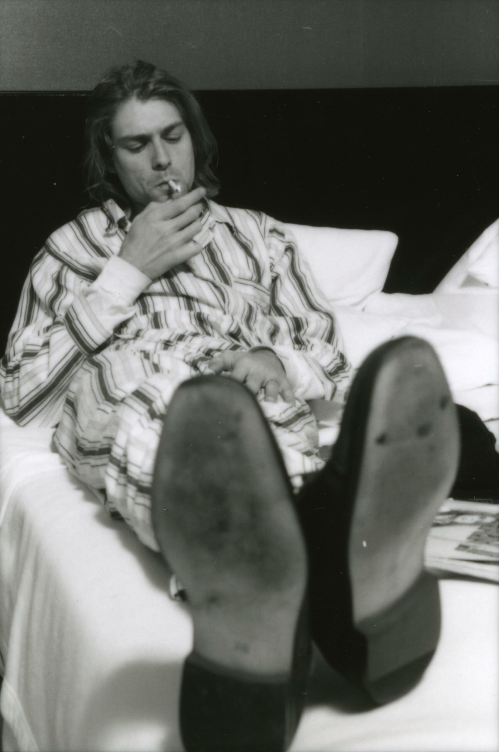 (MANDATORY CREDIT Gutchie Kojima/Shinko Music/Getty Images) Kurt Cobain of Nirvana, lying in bed wearing pyjamas and smoki...
