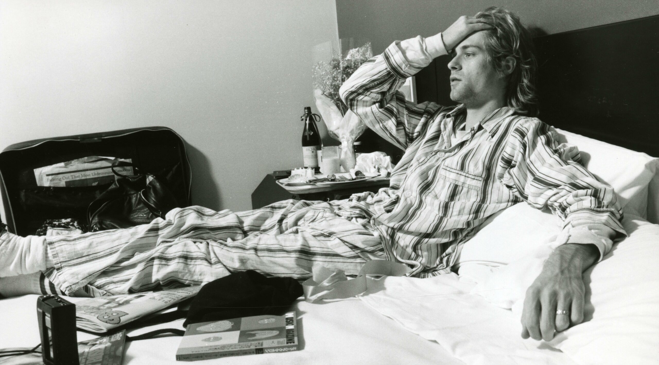 (MANDATORY CREDIT Gutchie Kojima/Shinko Music/Getty Images) Kurt Cobain of Nirvana, lying in bed wearing pyjamas in Roppon...