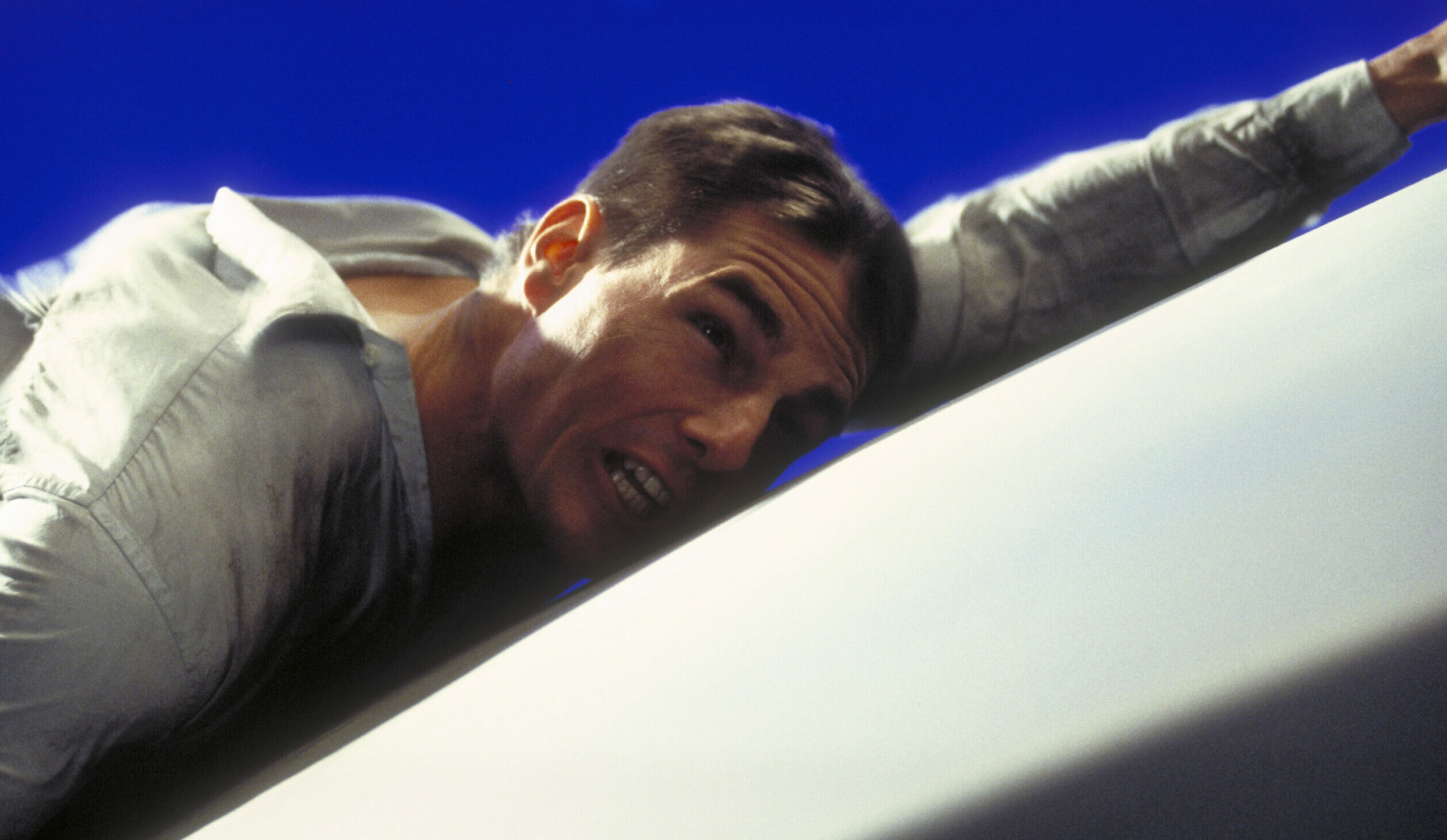 American actor Tom Cruise as Ethan Hunt, filming a scene for the movie 'Mission: Impossible' in a studio, 1995.  In this s...