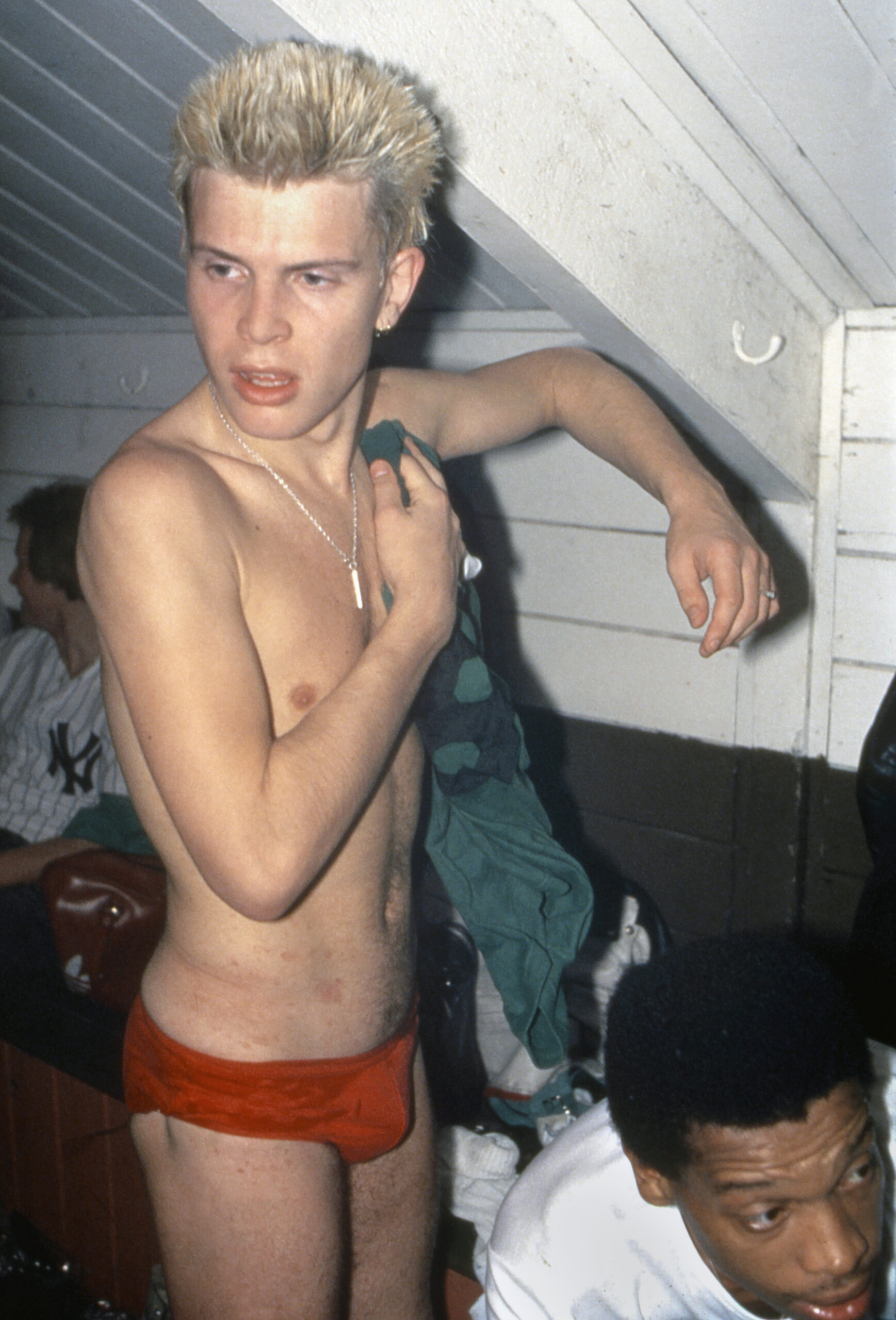 English singer Billy Idol towels himself off in his underwear after a sporting event, 1979. (Photo by Kypros/Getty Images)