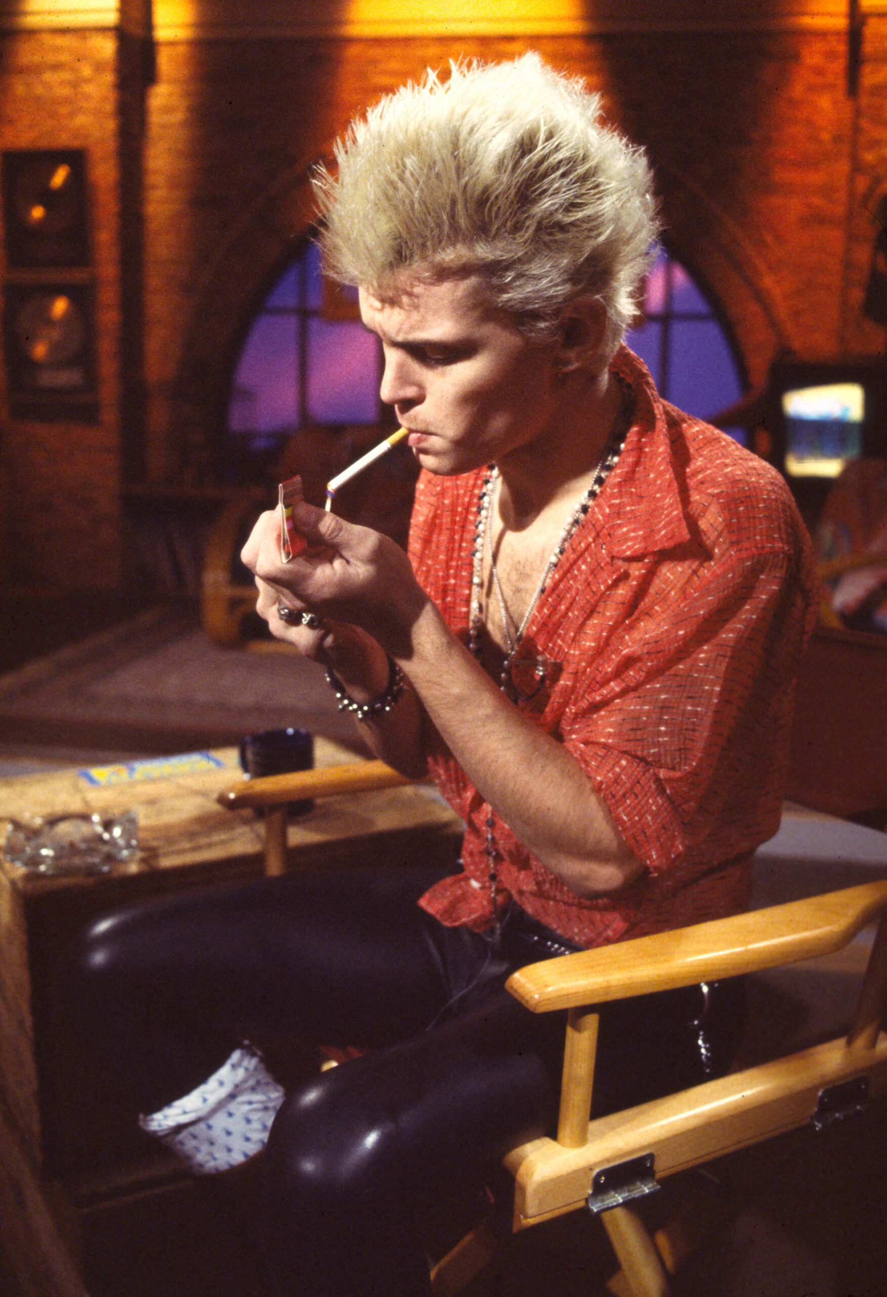 British Rock musician Billy Idol lights a cigarette during an interview at MTV Studios, New York, New York, December 6, 19...