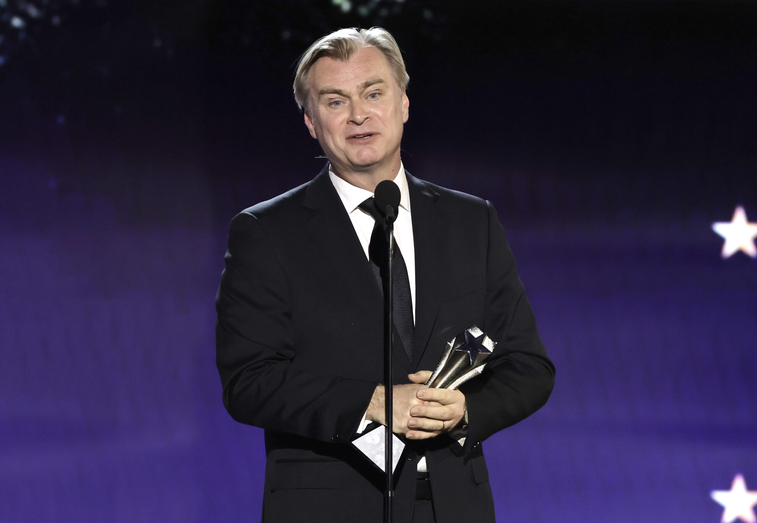 SANTA MONICA, CALIFORNIA - JANUARY 14: Christopher Nolan accepts the Best Director Award for 'Oppenheimer' onstage during ...