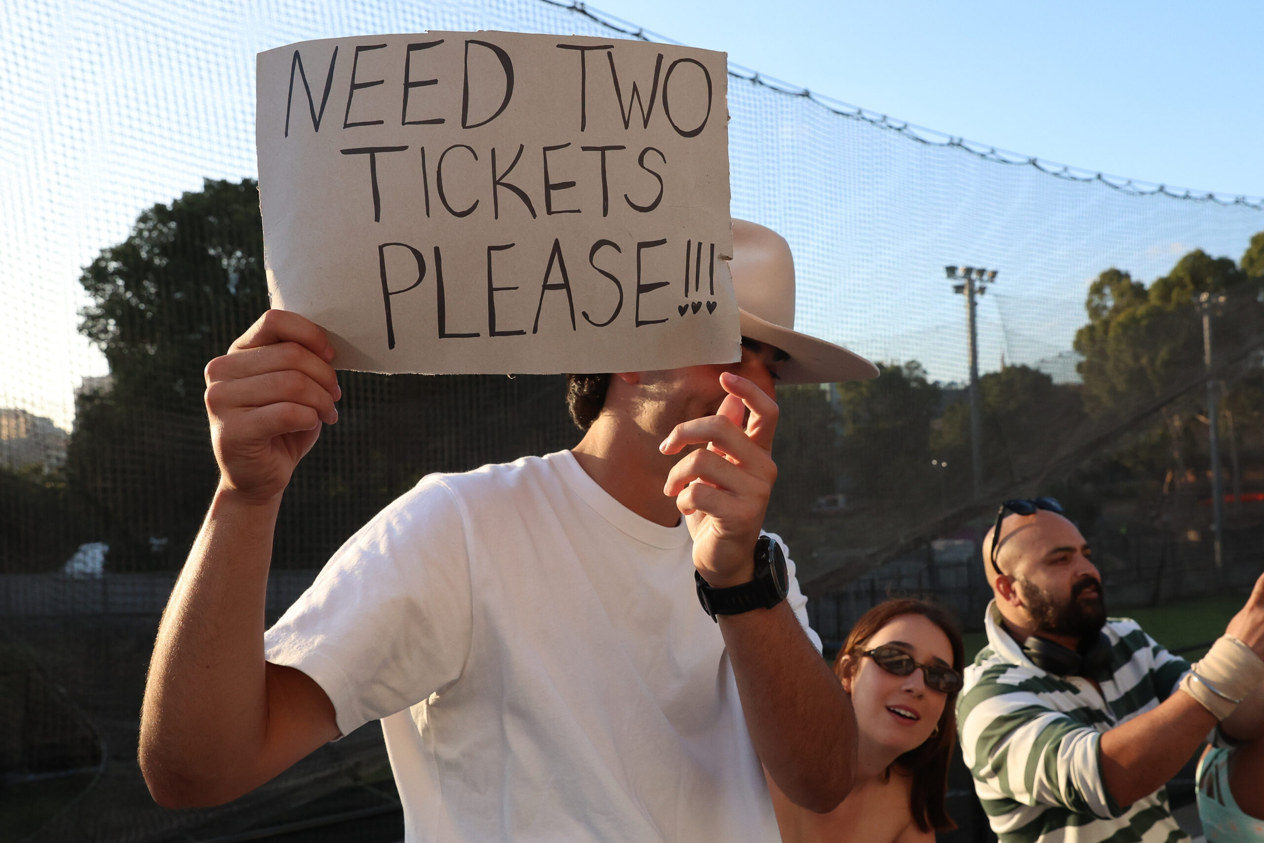 MELBOURNE, AUSTRALIA - FEBRUARY 16: A person holds a sign wanting tickets at Melbourne Cricket Ground on February 16, 2024...