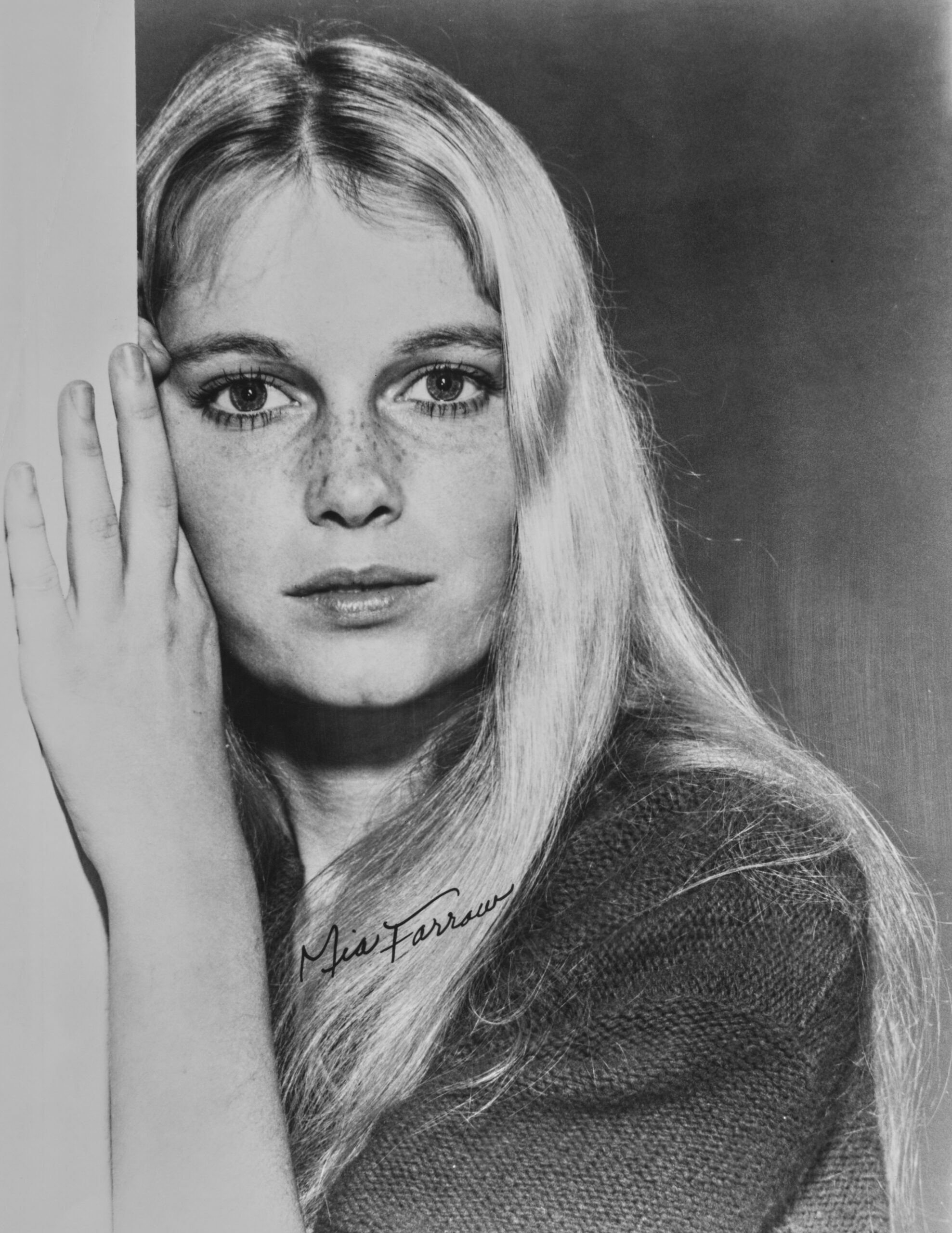 American actress Mia Farrow, her name handwritten across the image, wearing a sweater in a publicity still for the soap op...