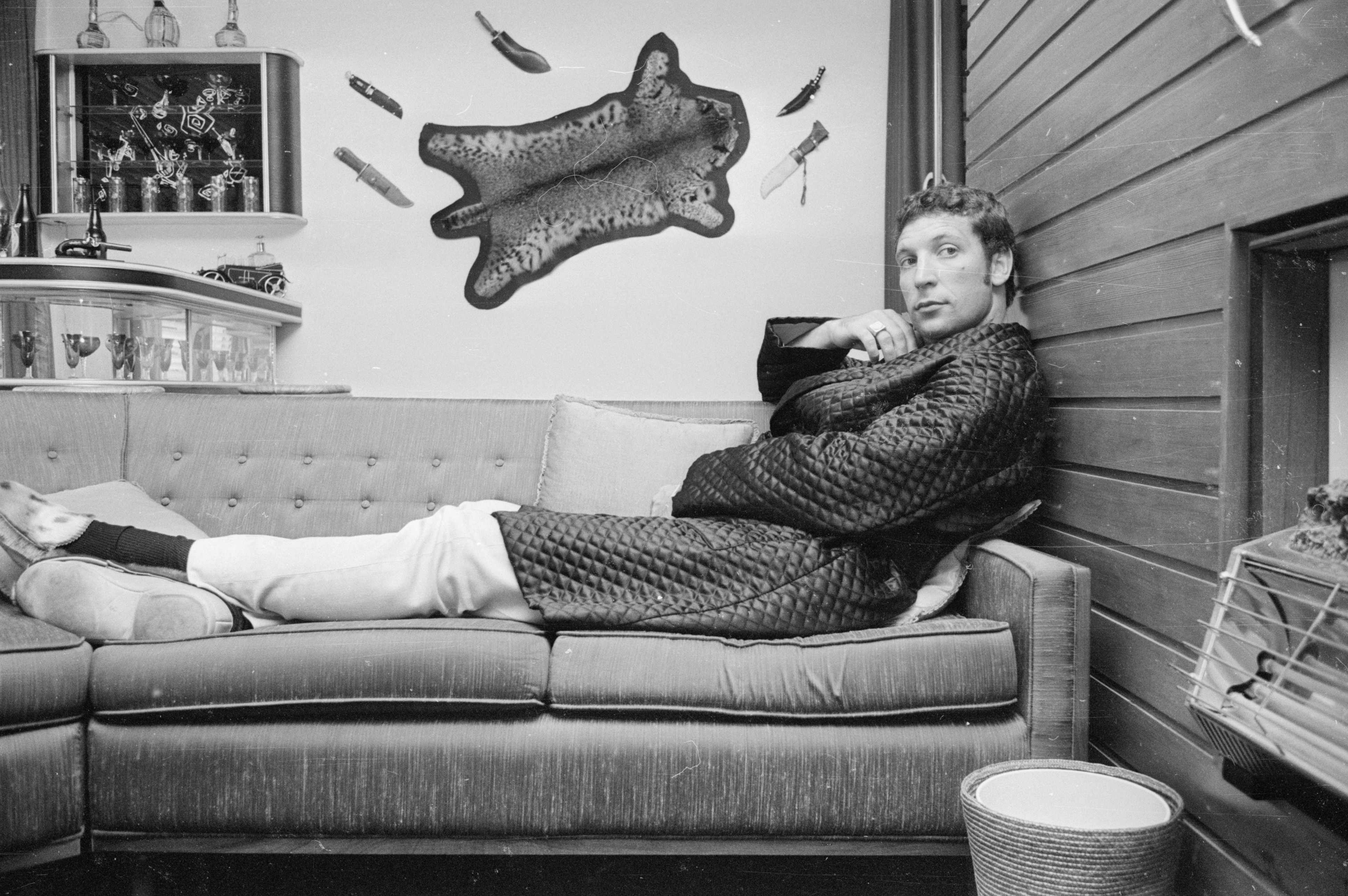 9th September 1966:  Welsh singer Tom Jones relaxes on a sofa at his home.  (Photo by Larry Ellis/Express/Getty Images)