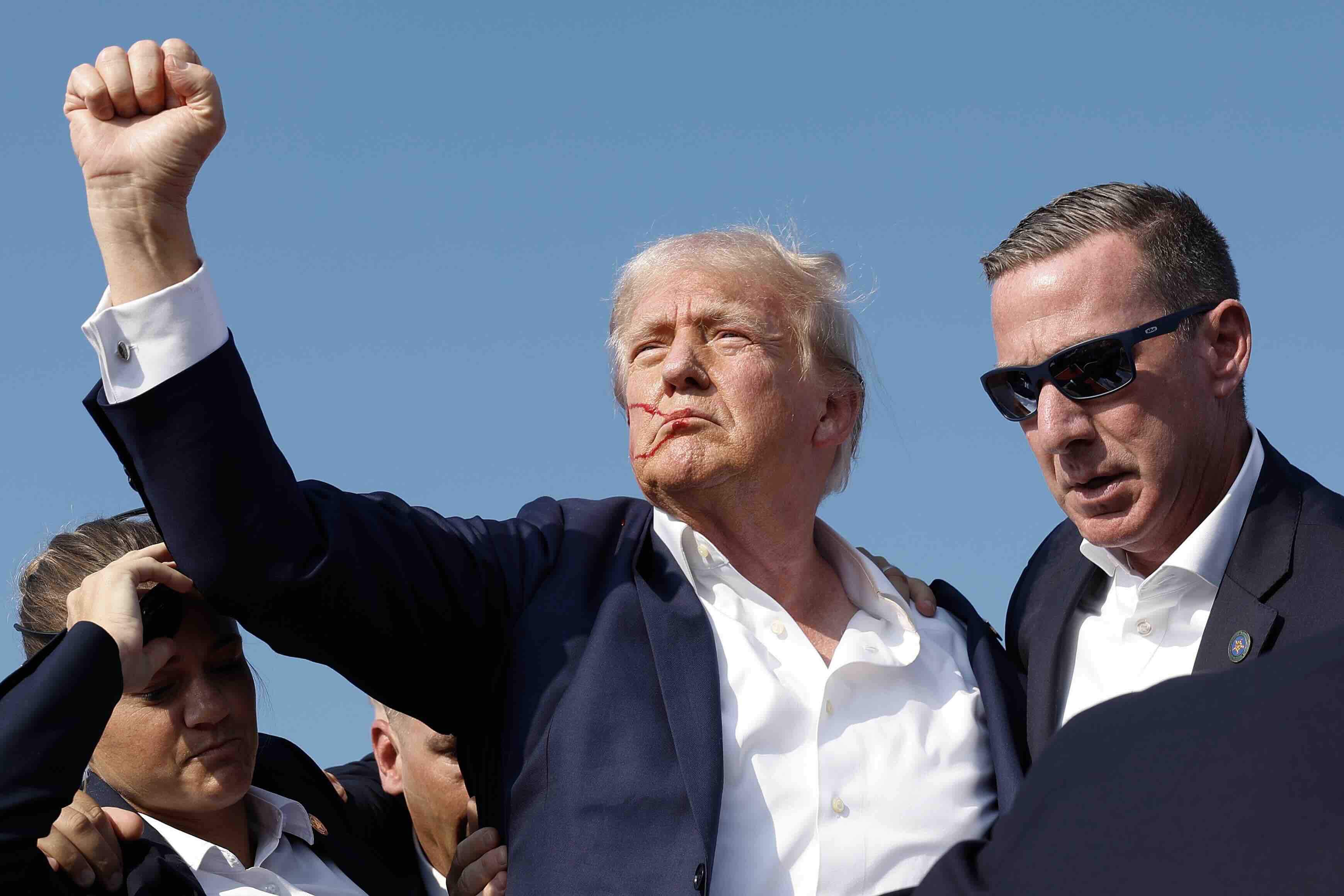 BUTLER, PENNSYLVANIA - JULY 13: Republican presidential candidate former President Donald Trump pumps his fist as he is ru...