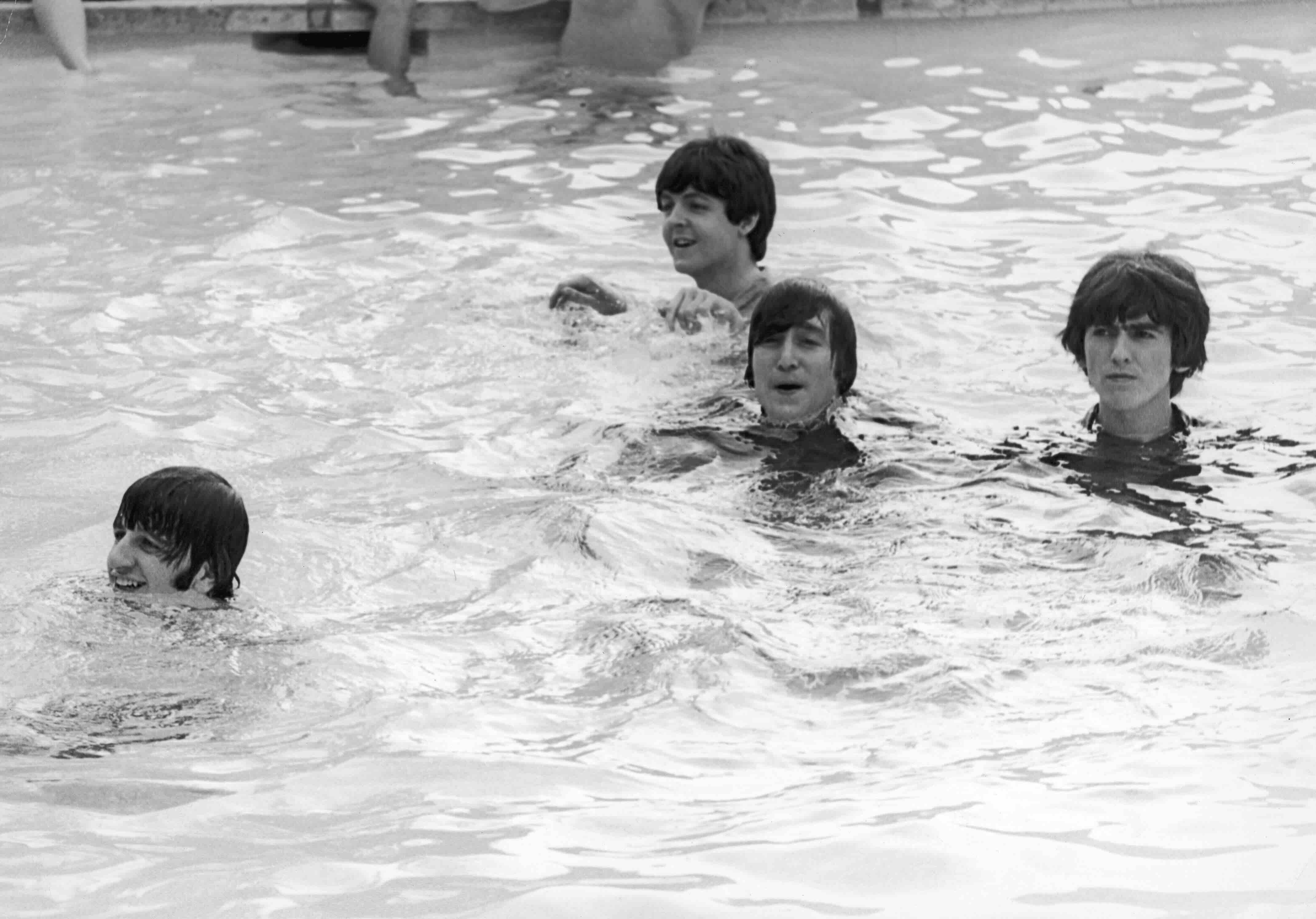 Members of the British rock group The Beatles tread water in a swimming pool during the filming of their movie, 'Help!,' N...