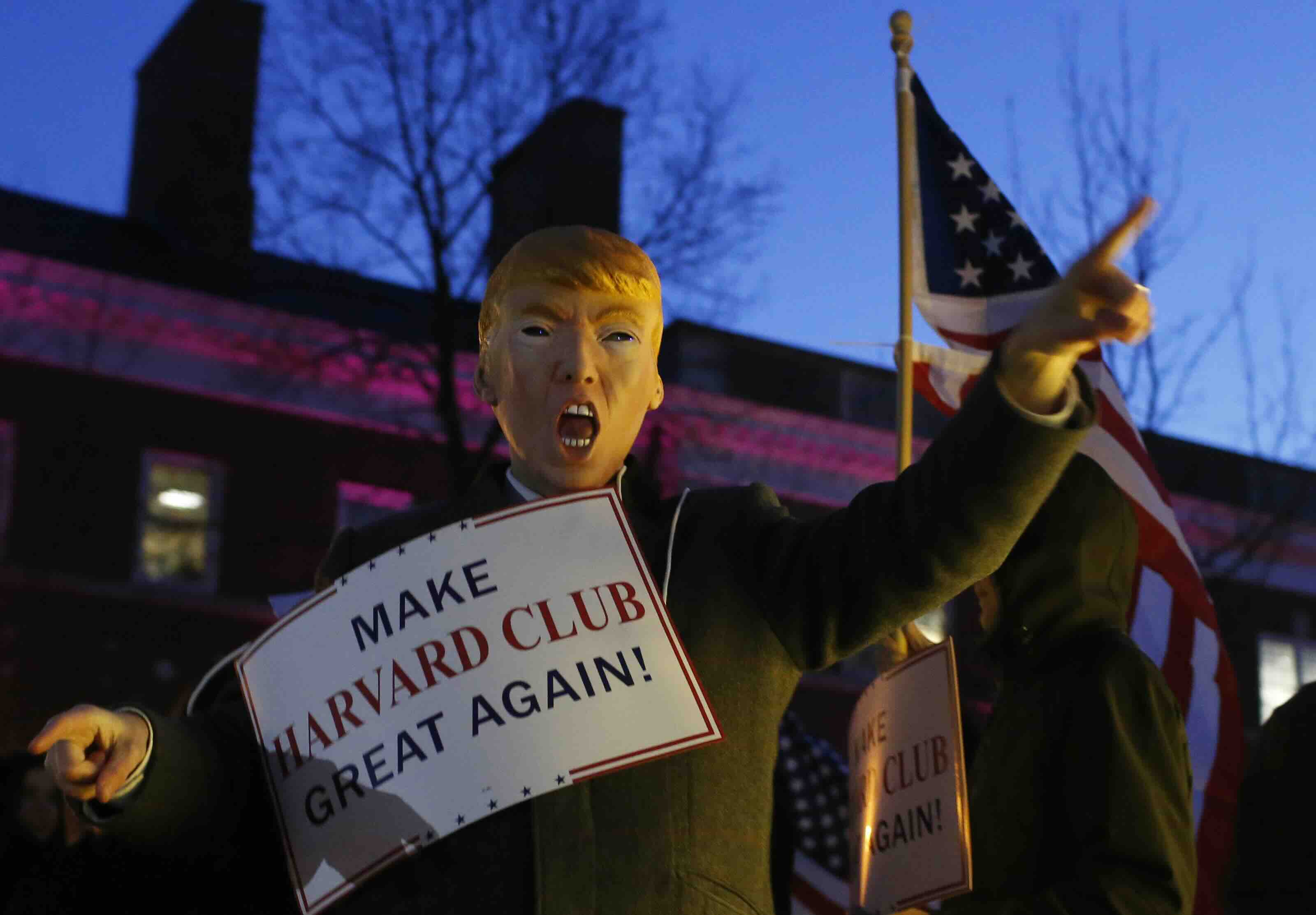 BOSTON - MARCH 1: People dressed as Donald Trump rally to 'Make Harvard Club Great Again' outside of a Harvard Alumni even...