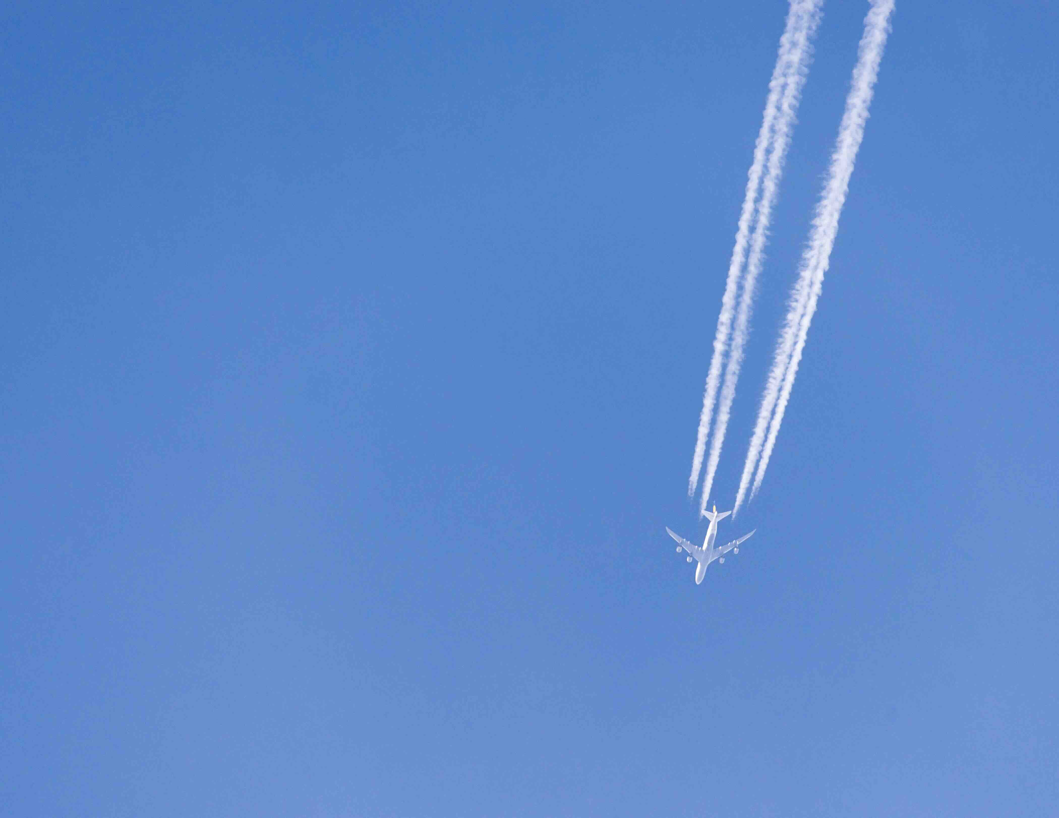 TORONTO, ONTARIO, CANADA - 2016/05/06: Contrails formed from engine exhaust of aeroplane against clear blue sky. Contrails...