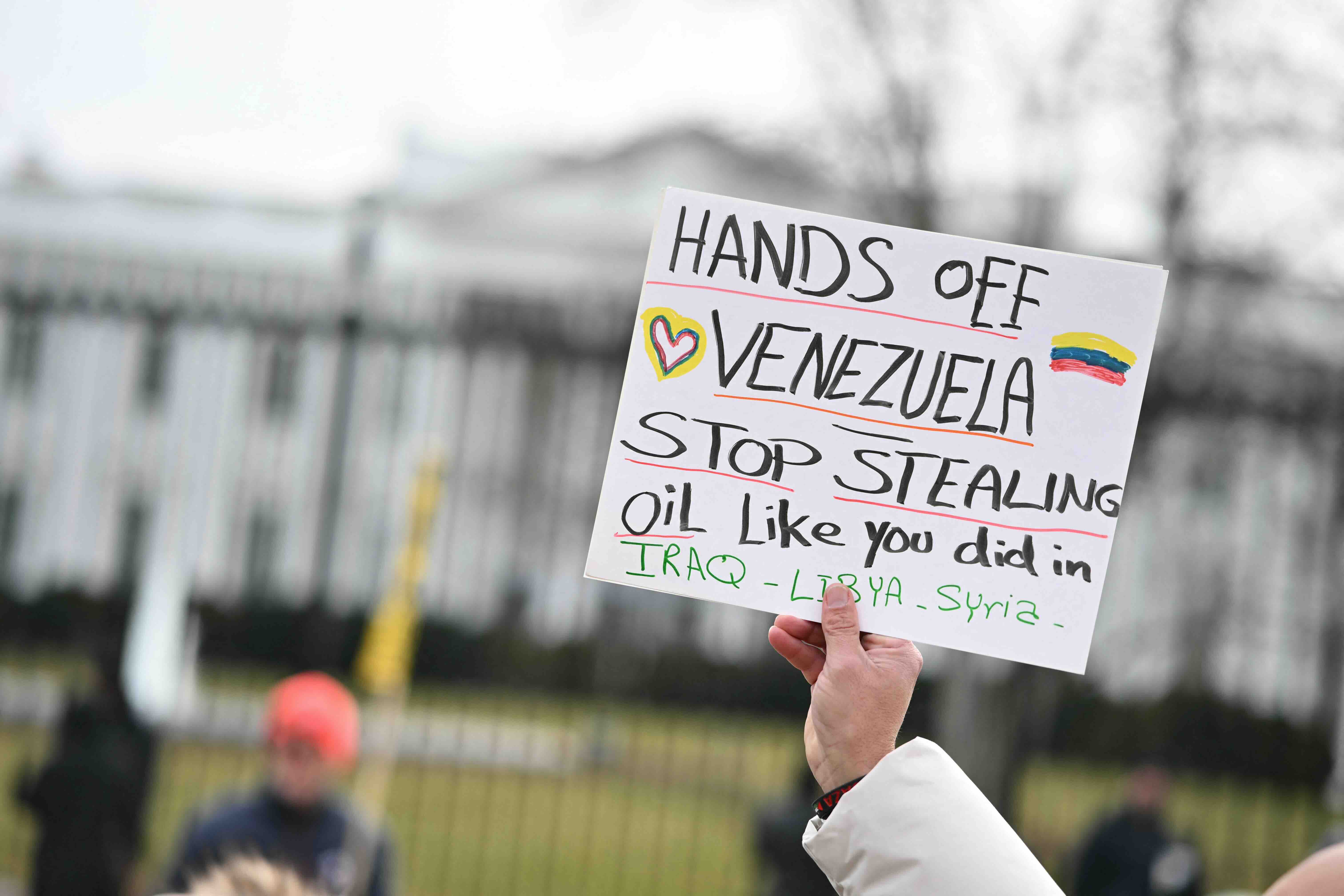 Protestors take part in a demonstration against US military action in Venezuela in Lafayette Square in front of the White ...