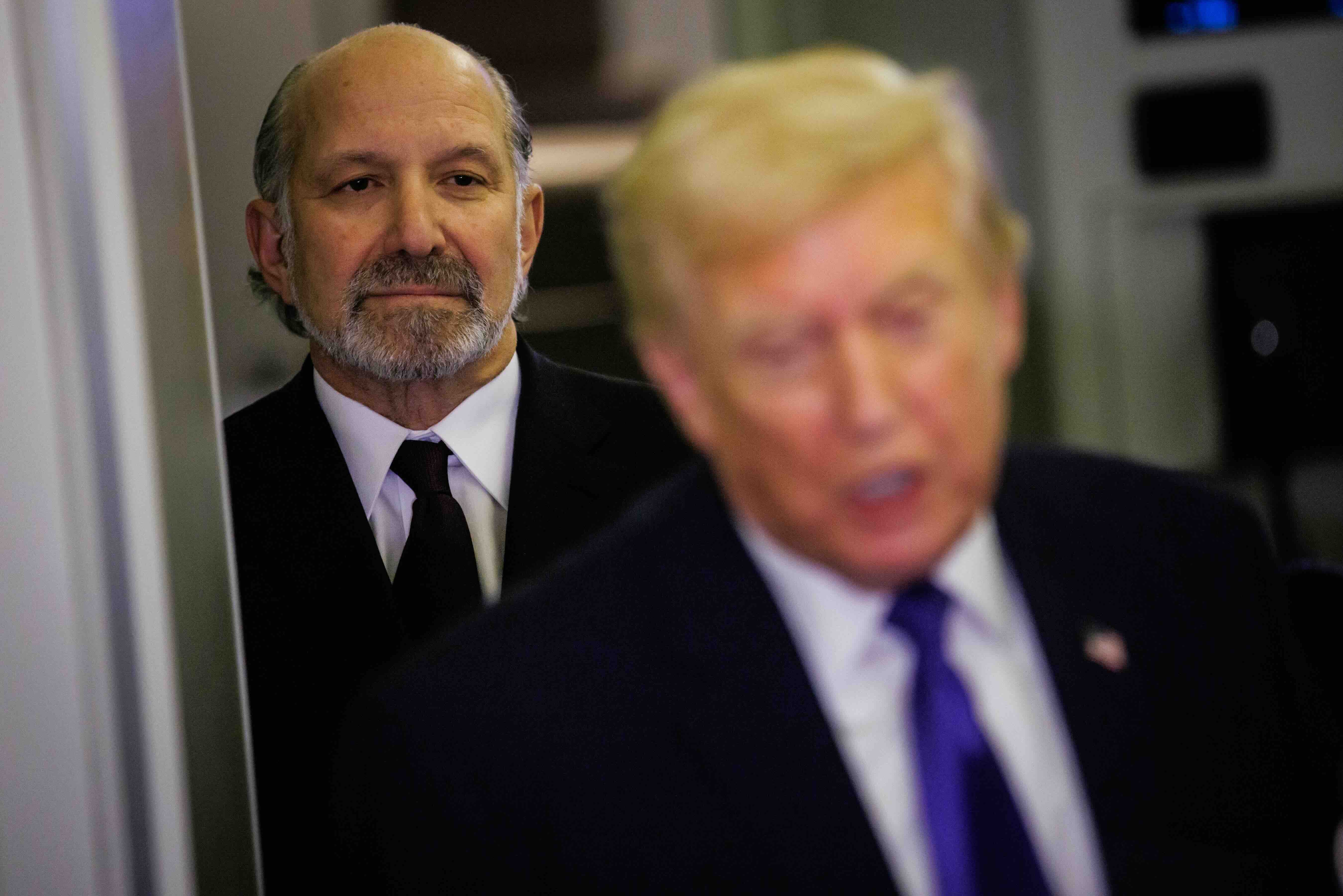 PALM BEACH, FLORIDA - FEBRUARY 6: U.S. Secretary of Commerce Howard Lutnick stands behind U.S. President Donald Trump as h...