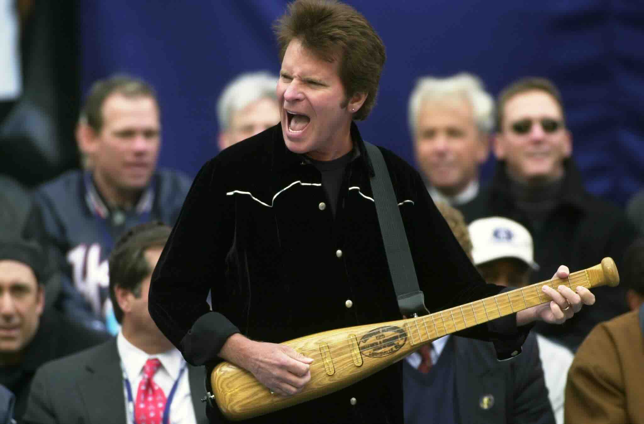 UNITED STATES - CIRCA 2000:  John Fogarty performs his baseball song "Centerfield" while playing a bat shaped guitar durin...