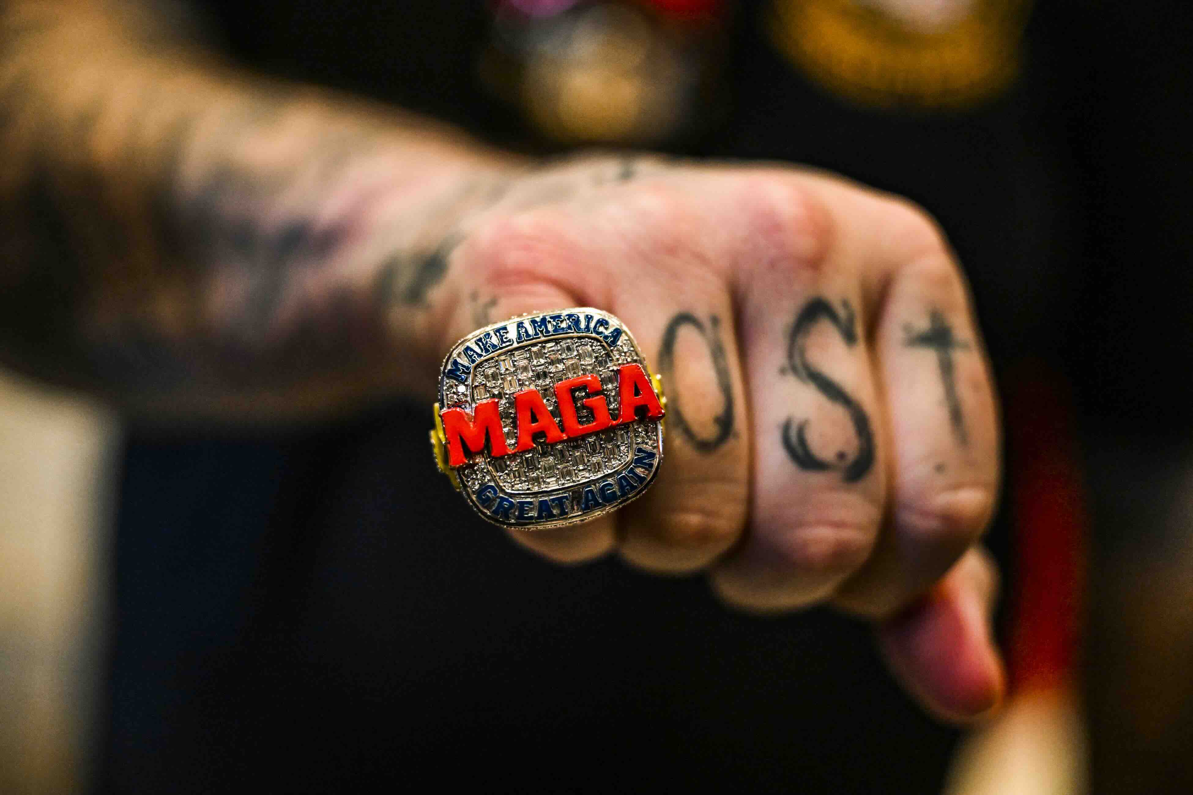A supporter of former US President and 2024 presidential hopeful Donald Trump wears a MAGA ring as he attends a Super Tues...