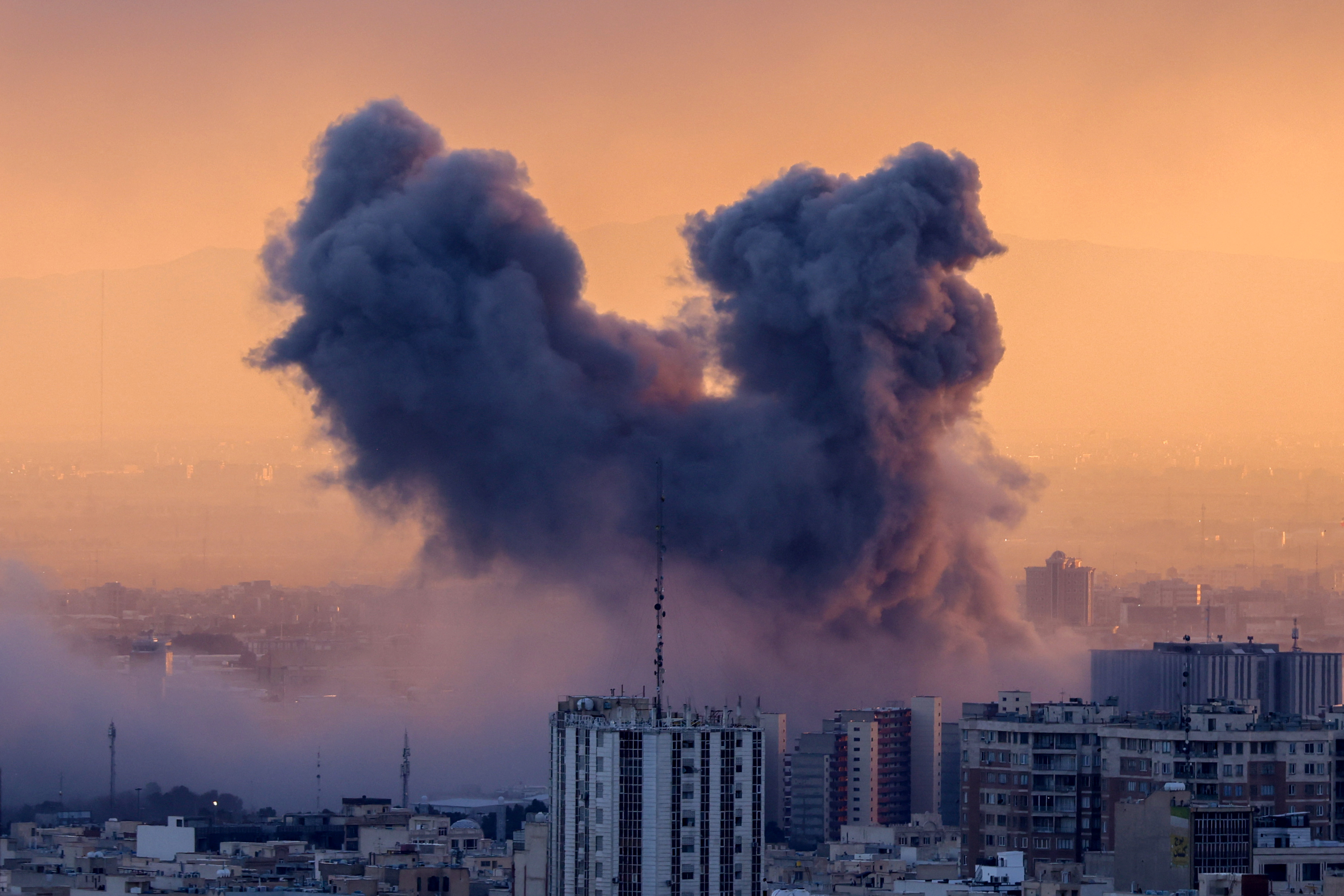 TOPSHOT - A plume of smoke rises after a strike on the Iranian capital Tehran, on March 3, 2026. Iran stepped up its attac...