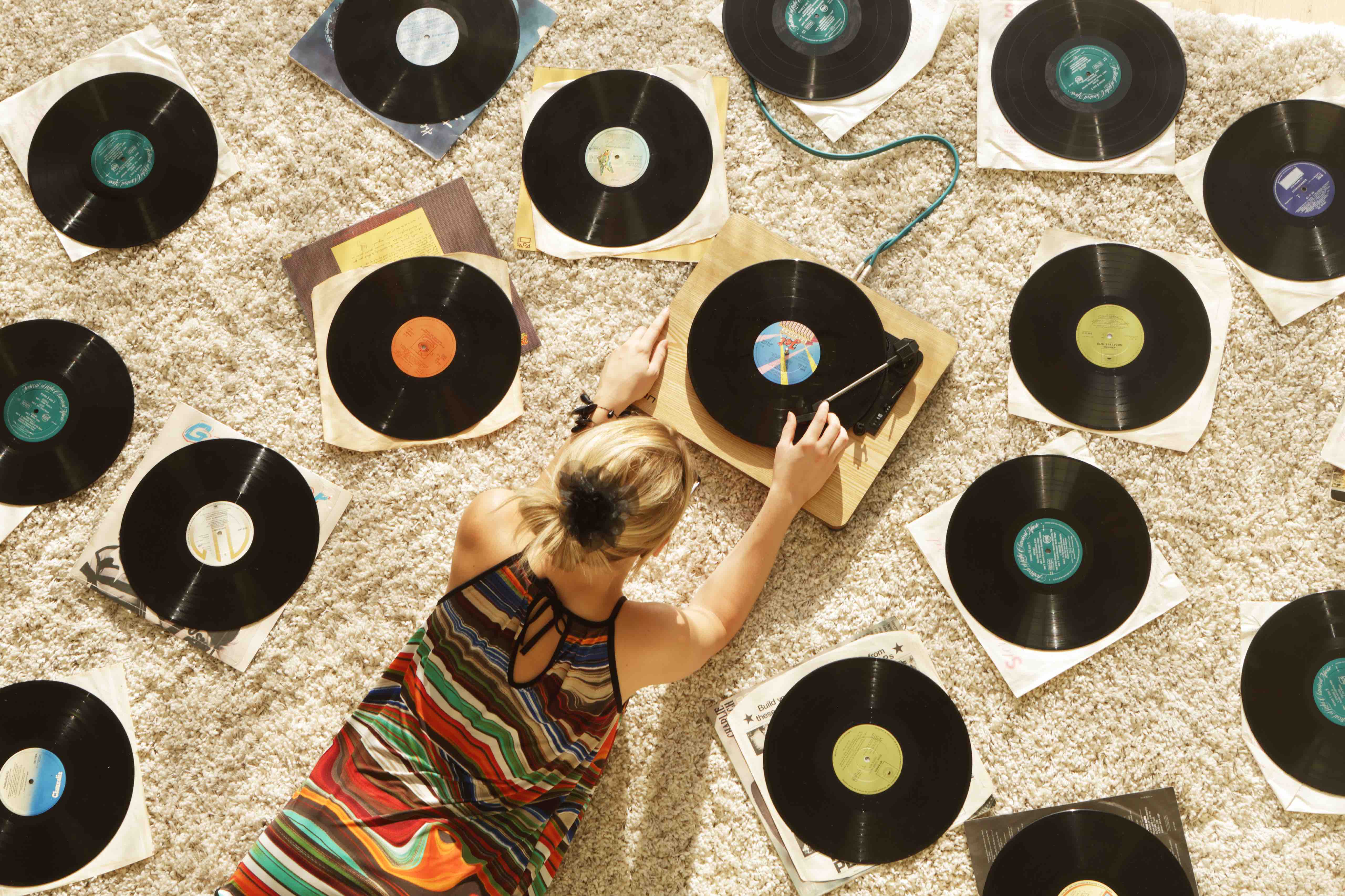 Woman on floor playing records