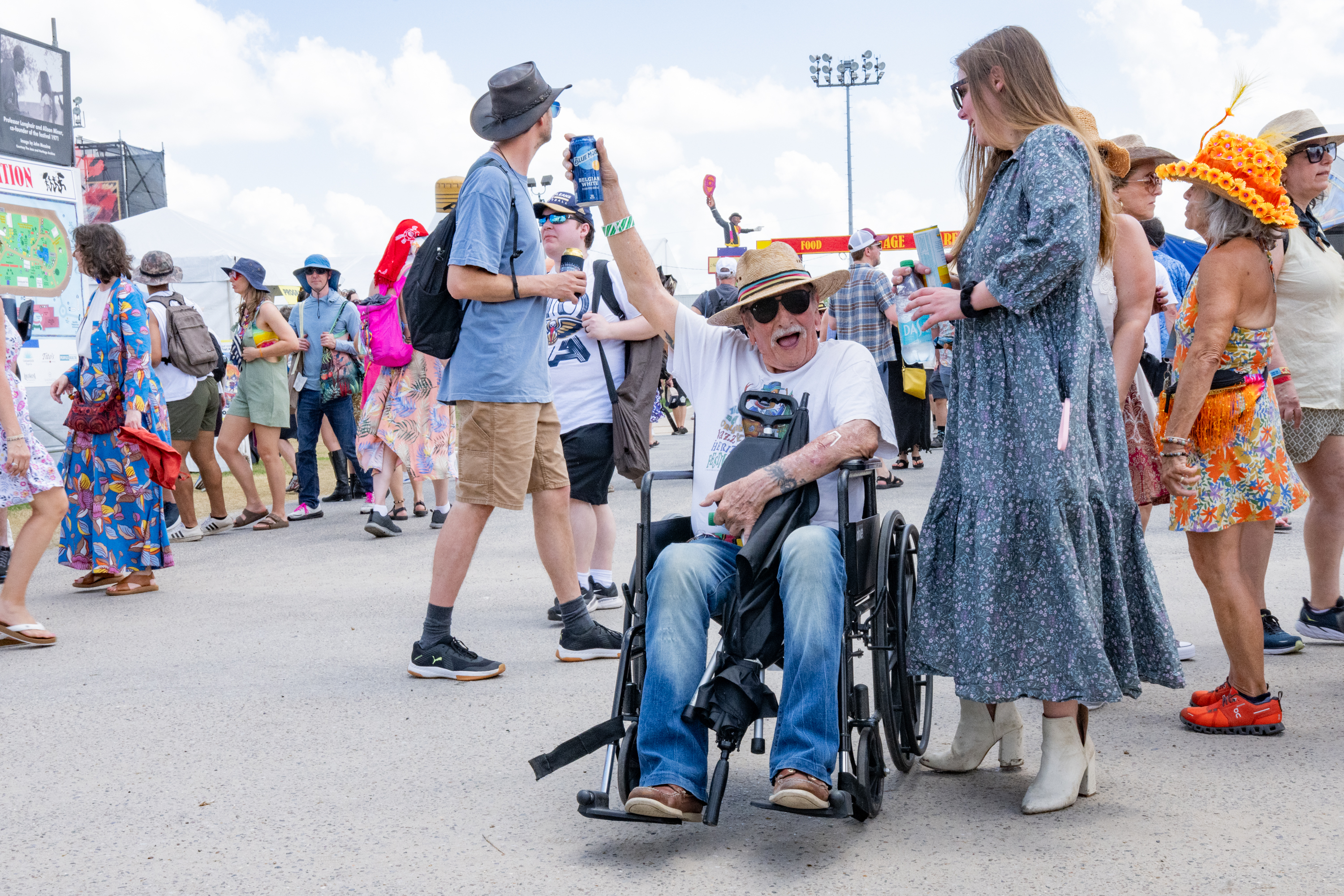 NEW ORLEANS, LOUISIANA - MAY 01: An attendee in a wheelchair celebrates with his drink during the 2025 New Orleans Jazz & ...