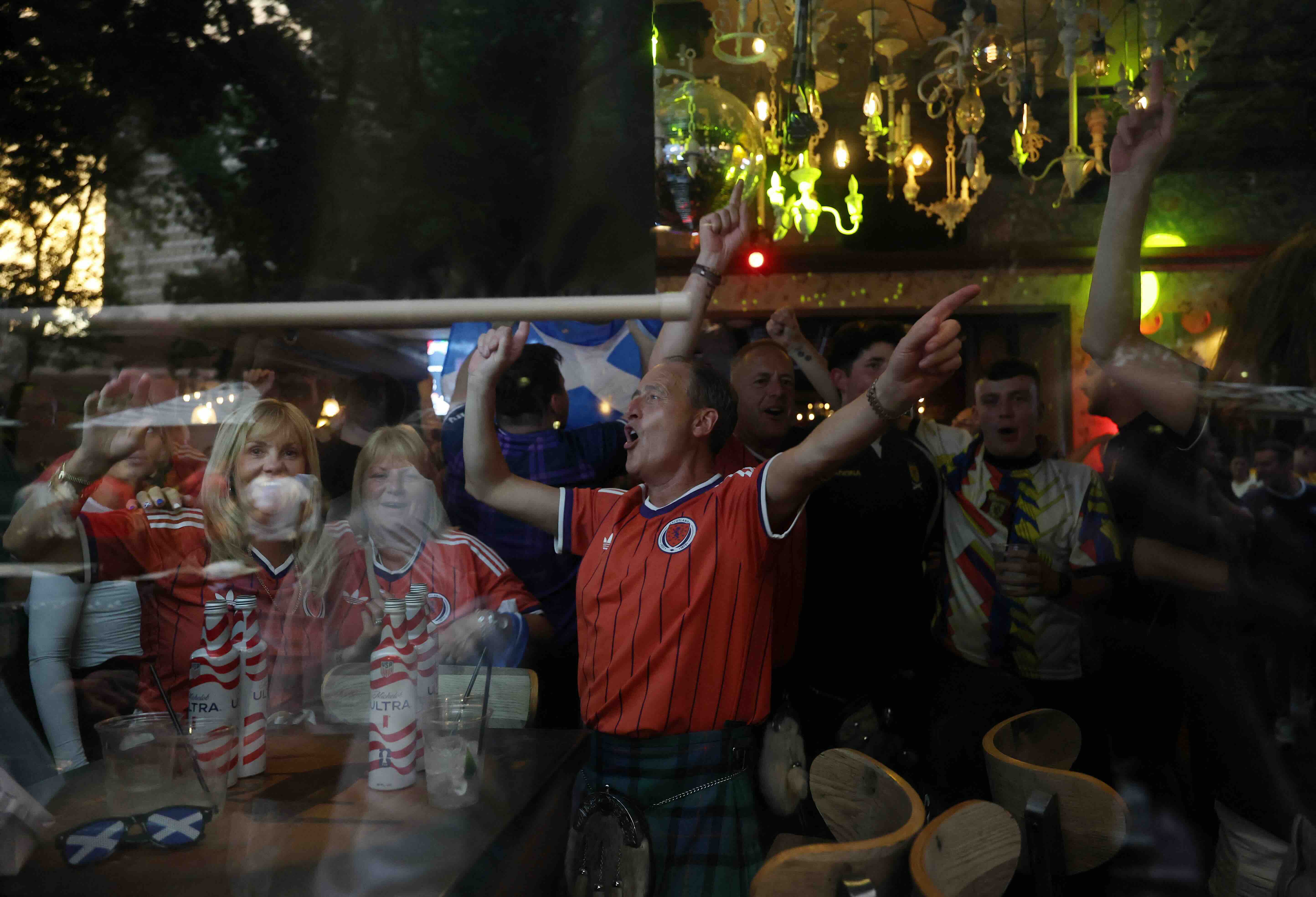 Scottish fans react as they gather on the eve of the 2026 World Cup Group C football match between Morocco and Scotland in...
